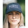 Girl wearing a navy baseball hat with Bateau restaurant logo